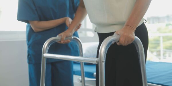 Female Using A Walker With Doctor Occupational Therapy